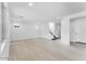 Spacious living room with large windows, clean white walls, and modern flooring leading to a staircase at 7820 E Quintana Ave, Mesa, AZ 85212