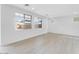 Bright and airy living room featuring modern flooring, large windows, and pristine white walls at 7820 E Quintana Ave, Mesa, AZ 85212