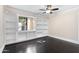 Bedroom with built-in shelving and dark hardwood floors at 9025 N 86Th Pl, Scottsdale, AZ 85258