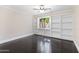 Bedroom with built-in shelving and dark hardwood floors at 9025 N 86Th Pl, Scottsdale, AZ 85258