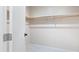 White spacious closet with wood hanging rods at 9025 N 86Th Pl, Scottsdale, AZ 85258