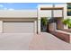 View of the garage and gated entry to a tan house at 9025 N 86Th Pl, Scottsdale, AZ 85258