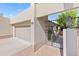 View of the garage and gated entry to a tan house at 9025 N 86Th Pl, Scottsdale, AZ 85258