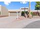 Front view of a tan house with a gated entry and brick walkway at 9025 N 86Th Pl, Scottsdale, AZ 85258