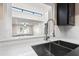 Kitchen with a view of the living room, featuring a modern sink and faucet at 9025 N 86Th Pl, Scottsdale, AZ 85258