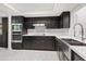 Updated kitchen featuring dark cabinetry, stainless steel appliances, and marble flooring at 9025 N 86Th Pl, Scottsdale, AZ 85258