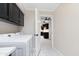 Laundry room with Samsung washer and dryer, and a view to the kitchen at 9025 N 86Th Pl, Scottsdale, AZ 85258