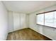 Well-lit bedroom with sliding closet doors and window coverings at 9054 N 51St Ln, Glendale, AZ 85302