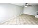 Open living area with tile floors and ceiling fan; view of the staircase at 9054 N 51St Ln, Glendale, AZ 85302