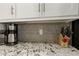 Granite countertop detail with coffee maker and knife block at 9637 E Sundune Dr, Sun Lakes, AZ 85248