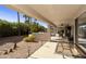 Covered patio with seating area and desert landscaping at 9637 E Sundune Dr, Sun Lakes, AZ 85248