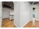 Hallway with hardwood floors and a view into the kitchen at 1 E Lexington Ave # 701, Phoenix, AZ 85012