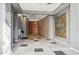 Modern hallway with tiled floors and artwork at 1 E Lexington Ave # 701, Phoenix, AZ 85012