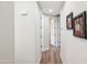 Hallway with wood floors and artwork on the walls at 10055 N 142Nd St # 1310, Scottsdale, AZ 85259