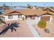 Single story home with lake view, two-car garage, and landscaped yard at 10178 W San Lazaro Dr, Arizona City, AZ 85123