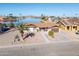 Aerial view of single-story home with water access and surrounding construction at 10178 W San Lazaro Dr, Arizona City, AZ 85123