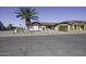 Single story home with white brick exterior and palm tree in front yard at 10178 W San Lazaro Dr, Arizona City, AZ 85123