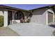 Brick home exterior with covered porch, two chairs, and holiday decor at 10178 W San Lazaro Dr, Arizona City, AZ 85123