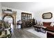 Living room with hardwood floors, red sofa, and decorative accents at 10178 W San Lazaro Dr, Arizona City, AZ 85123