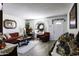 Bright and airy living room with hardwood floors, a red sofa and armchair at 10178 W San Lazaro Dr, Arizona City, AZ 85123