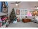 Bright living room with comfortable seating and a Christmas tree at 10178 W San Lazaro Dr, Arizona City, AZ 85123