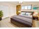 Virtually staged main bedroom with a gray bedding set and ample closet space at 102 W Maryland Ave # B2, Phoenix, AZ 85013