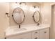 Bright bathroom with double sinks, quartz countertop, and oval mirrors at 11252 N 37Th St, Phoenix, AZ 85028