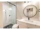 Stylish bathroom, featuring a round mirror and white vanity at 11252 N 37Th St, Phoenix, AZ 85028