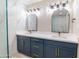 Elegant bathroom with double vanity, marble tile, and modern lighting at 11252 N 37Th St, Phoenix, AZ 85028