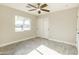 Spacious bedroom with ceiling fan and large window at 11252 N 37Th St, Phoenix, AZ 85028