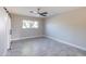 Bright bedroom with ceiling fan and gray tile flooring at 11252 N 37Th St, Phoenix, AZ 85028