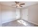 Bright bedroom with ceiling fan and wood-look tile floors at 11252 N 37Th St, Phoenix, AZ 85028