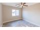 Well-lit bedroom, featuring a ceiling fan and window at 11252 N 37Th St, Phoenix, AZ 85028