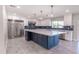 Modern kitchen with white cabinets, blue tile backsplash, and large island at 11252 N 37Th St, Phoenix, AZ 85028