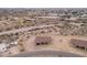 Aerial view showcasing a new home's exterior and surrounding desert landscape at 125 Ironwood Pl, Wickenburg, AZ 85390