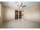 Bedroom with tile floors, ceiling fan, and access to other rooms at 125 Ironwood Pl, Wickenburg, AZ 85390