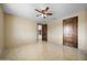 Bright bedroom with tile floors and ceiling fan at 125 Ironwood Pl, Wickenburg, AZ 85390