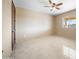 Spacious bedroom with tile floors and ceiling fan at 125 Ironwood Pl, Wickenburg, AZ 85390