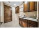 Laundry room with wooden cabinets and a built-in sink at 125 Ironwood Pl, Wickenburg, AZ 85390