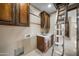 Laundry room with wooden cabinets, sink, and attic access at 125 Ironwood Pl, Wickenburg, AZ 85390