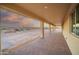 Covered patio with brick pavers and view of desert landscape at 125 Ironwood Pl, Wickenburg, AZ 85390