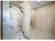 Walk-in shower with marble tile and glass door at 125 Ironwood Pl, Wickenburg, AZ 85390