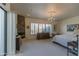 Primary bedroom with stone fireplace and large windows at 11736 E Del Timbre Dr, Scottsdale, AZ 85259