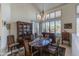 Formal dining room with wood table, chandelier, and built-in hutch at 11736 E Del Timbre Dr, Scottsdale, AZ 85259