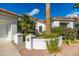 Front entry of house with white wall and manicured landscaping at 11736 E Del Timbre Dr, Scottsdale, AZ 85259