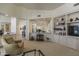 Living room with built-in shelving and views into kitchen and dining areas at 11736 E Del Timbre Dr, Scottsdale, AZ 85259