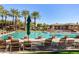 Sparkling community pool with lounge chairs and palm trees at 11736 E Del Timbre Dr, Scottsdale, AZ 85259