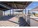 Outdoor grilling area with tables and chairs under a covered patio at 1223 W Sparrow Dr, Queen Creek, AZ 85140