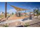 Modern playground with shade structures and a safe surface at 1223 W Sparrow Dr, Queen Creek, AZ 85140