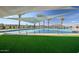 Relaxing pool area with shade structures and artificial turf at 1223 W Sparrow Dr, Queen Creek, AZ 85140